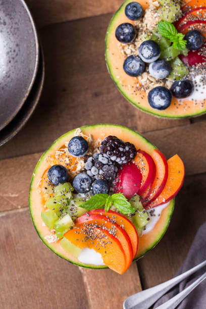 istock Fruit salad with yogurt in carved melon cantaloupe bowl 1321093241
