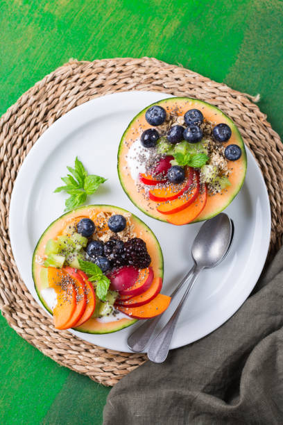 istock Fruit salad with yogurt in carved melon cantaloupe bowl 1321093356