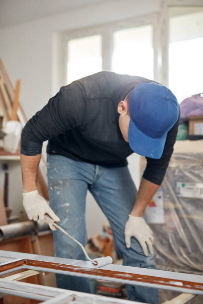 Young adult man painting on a DIY budget renovation of his new home apartment. Young adult man painting on a DIY budget renovation of his new home apartment. hobbyist stock pictures, royalty-free photos & images