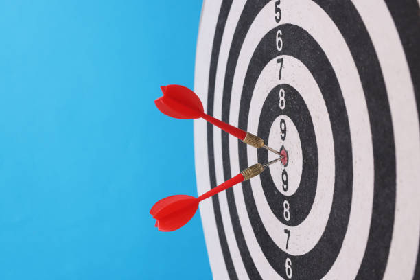 istock Game darts in center with darts on blue background. 1321097280