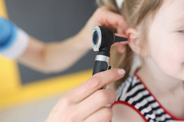 doctor examines ear drum of little girl - young ears imagens e fotografias de stock