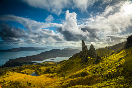 Dramatic clouds over the Old Man of Storr rock formation on the Trotternish peninsula of the Isle of Skye in Scotland. Back lit by bright sunlight.