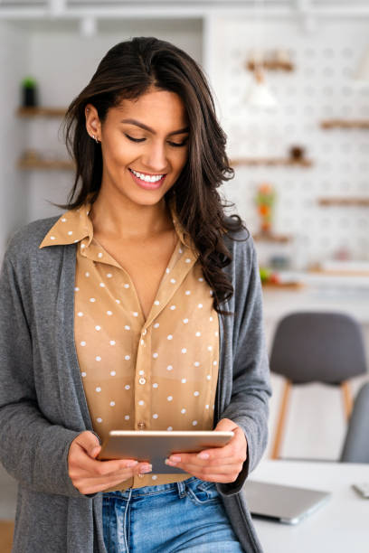 istock Happy beautiful woman using technology device to work, study at home. Social media time. 1321098768