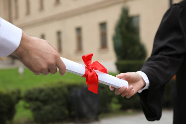 istock Student receiving diploma during graduation ceremony outdoors, closeup 1321100609