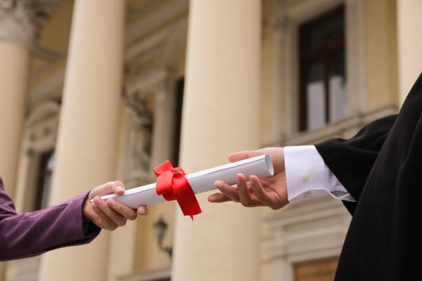istock Student receiving diploma during graduation ceremony outdoors, closeup 1321100638