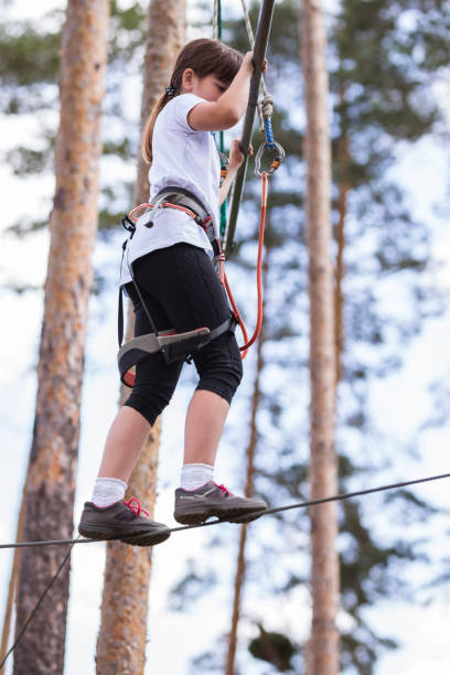 istock Young girl walking on chord at adrenalin park 1321100768