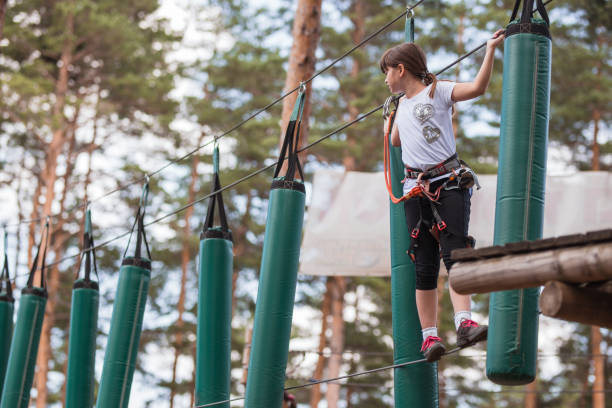 istock Child walking on a string in air at amusement park 1321100780