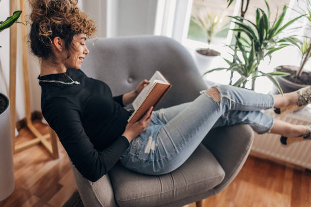 istock Beautiful woman reading a book 1321101980