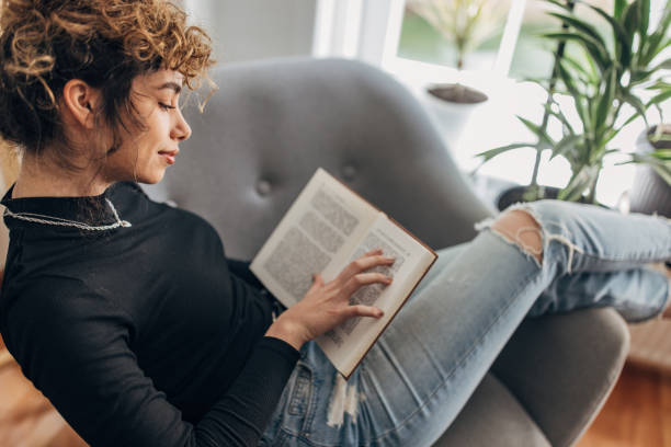 istock Beautiful woman reading a book 1321102018
