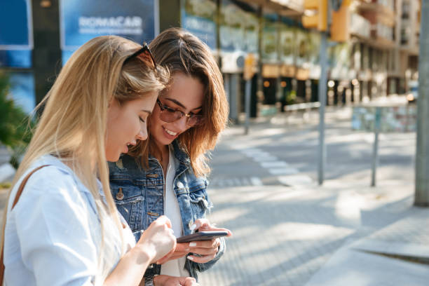 istock Two amazing women friends using mobile phone. 1321102021