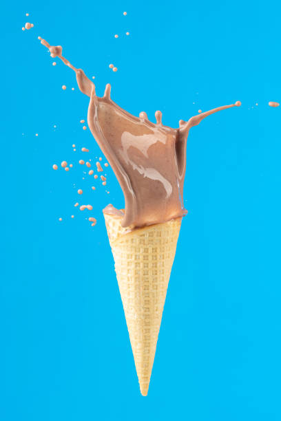 istock Chocolate milk splash and ice-cream cone 1321102625