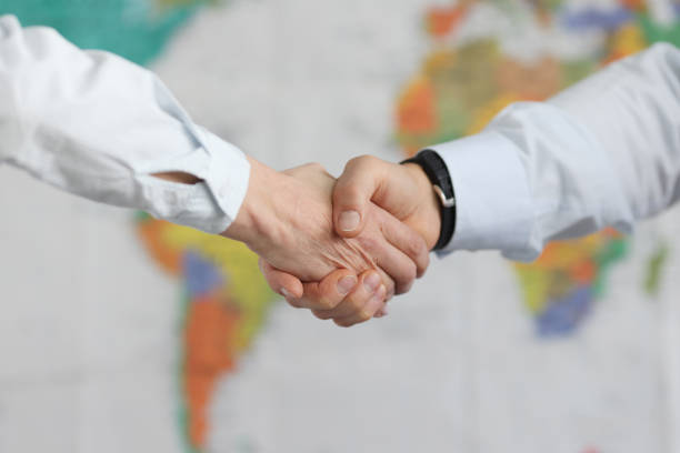 Business people handshake on background of world map of world Business people handshake on background of world map of world. International treaty and political agreements concept diplomacy stock pictures, royalty-free photos & images