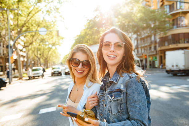 istock Two amazing women friends using mobile phone. 1321105046