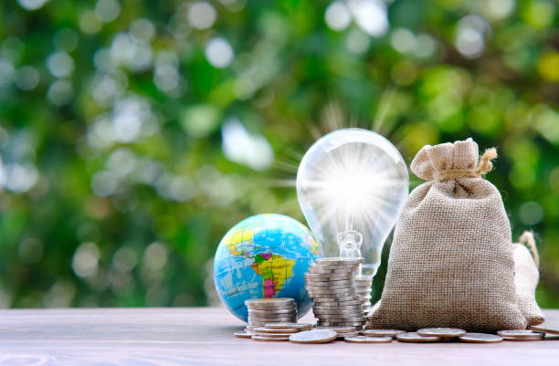 istock saving money concept, stacking coins with globe on green bokeh background, Advertising coins of finance and banking, business growth concept 1321106202