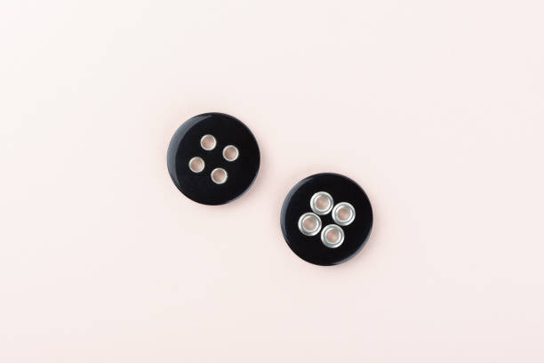 istock Two black plastic buttons on both sides with metal inserts in the holes. 1321107457