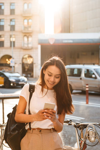 istock Amazing smiling beautiful woman on bicycle using mobile phone. 1321110229