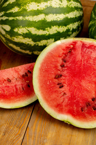 istock Watermelon and watermelon slice on wooden background 1321110245