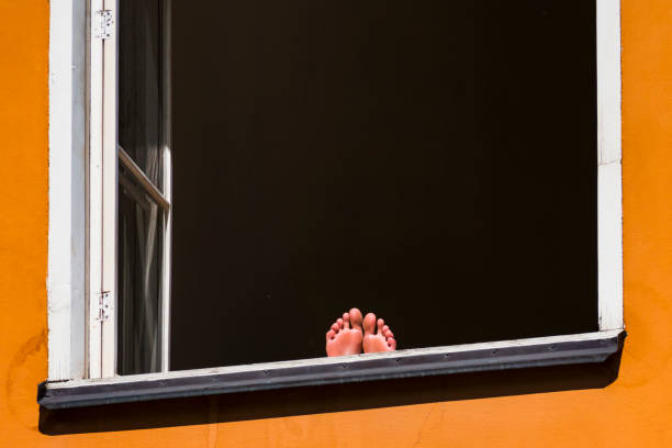 Stockholm, Sweden Feet on the windowsill in the sun in the  Sodermalm neighbourhood.