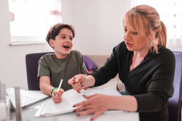 istock Woman helping her son with homework as he laughs at her 1321110819