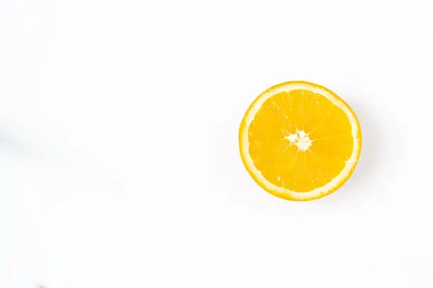Top view of one orange round fruit on a white background. Rich citrus texture. Copy space.