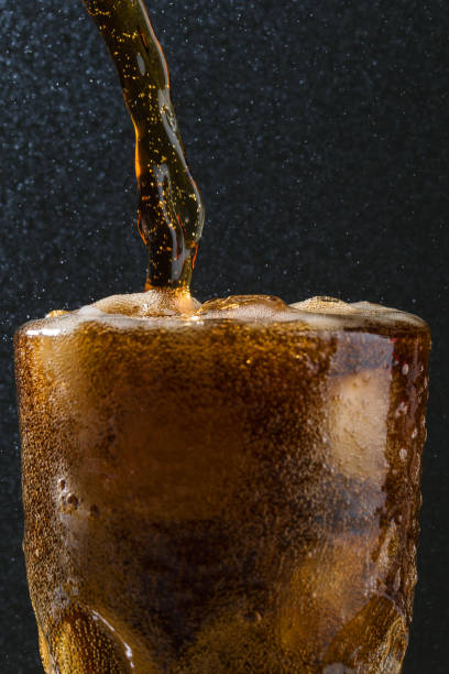 istock Soda drinks pouring into glass macro in studio 1321113318