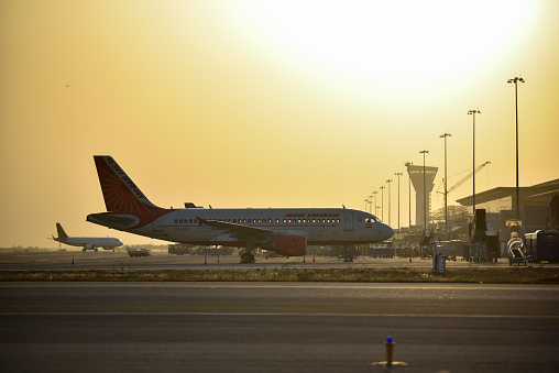 A silhouetted Air India passenger flight parked at Rajiv Gandhi International Airport (RGIA) , Hyderabad.