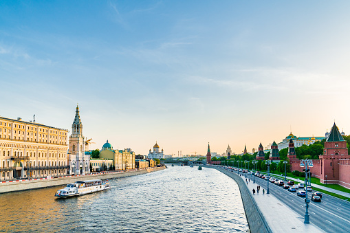 Sunset in Moscow - view to The Kremlin and Sofiyskaya embankment from Bolshoy Moskvoretsky Bridge. Cloudless sky is on the background.