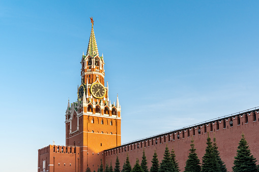 The Spasskaya Tower (Spasskaya Bashnya) of the Moscow Kremlin on the blue cloudless sky background.