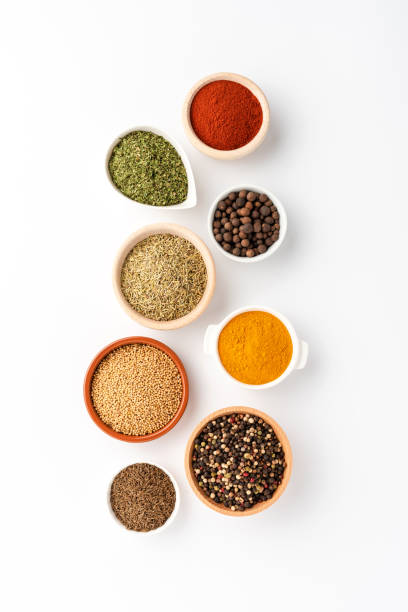 istock Various kinds of seasonings in bowls on white table. Top view 1321117532