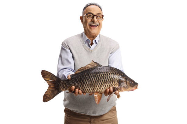 istock Excited mature casual man holding a big carp fish 1321117815