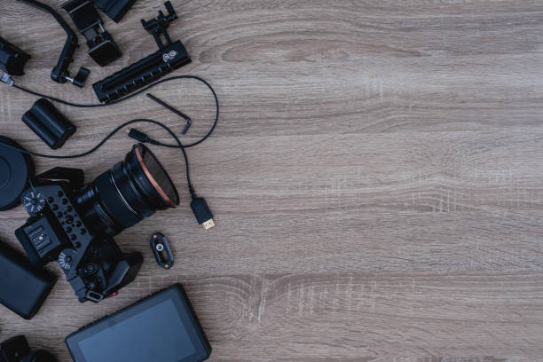 istock top view of work space photographer with digital camera, flash, cleaning kit, memory card, tripod and camera accessory on black table background 1321118668
