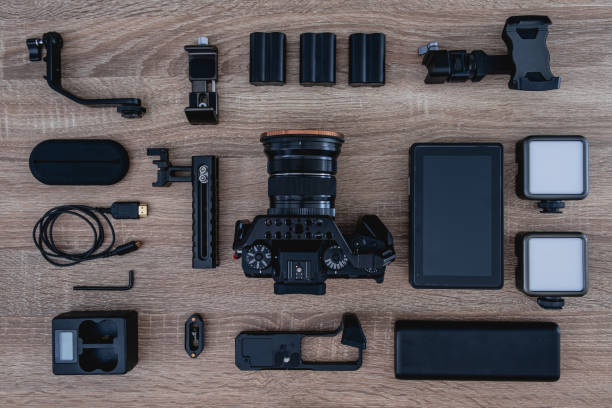 istock top view of work space photographer with digital camera, flash, cleaning kit, memory card, tripod and camera accessory on black table background 1321118671