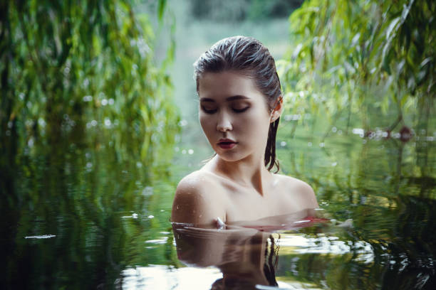 istock Beautiful young girl resting in water 1321118712