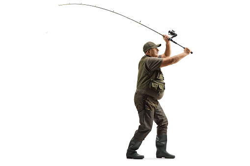 Full length profile shot of a fisherman throwing a fishing rod isolated on white background