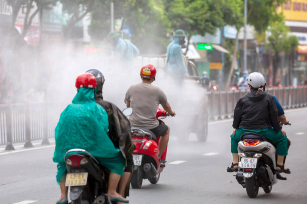 Disinfectant sprayed at Go Vap district for preventing Covid-19 spread Today many military trucks of Military Zone 7 have sprayed disinfectant along many highly traffic streets in Go Vap district, Ho Chi Minh city tp prevent Covid-19 spread. Within these 2 weeks over one hundred of cases founded positive in the community.
Many people traveled behind the truck in action in Quang Trung street, Go Vap district, Ho Chi Minh city vietnamese man taxi motorbike driver stock pictures, royalty-free photos & images