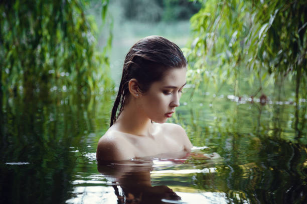 istock Beautiful young girl resting in water 1321120038
