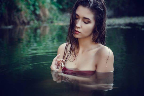istock Beautiful young girl resting in water 1321120342