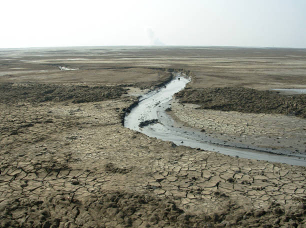 Barren scenery of Lapindo hot mud disaster Barren scenery of Lapindo hot mud disaster. A dried stream of hot mud is visible. Thousands of nearby residents were affected by the eruption mud volcano stock pictures, royalty-free photos & images