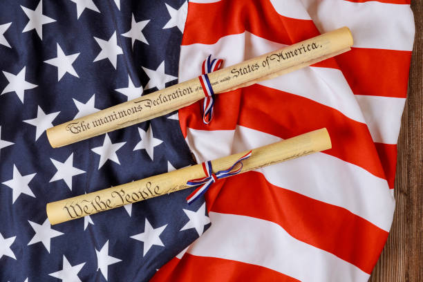 istock Fourth of July Day. Declaration of Independence parchment roll document with US flag. 1321123542
