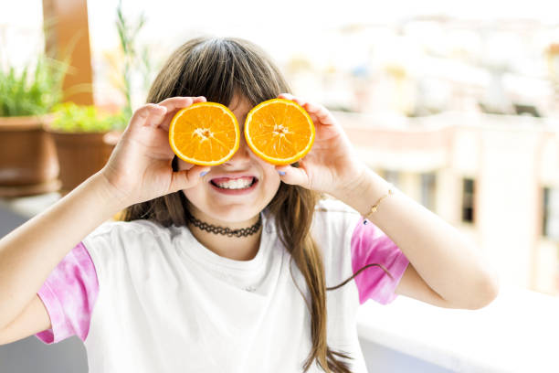 istock Beautiful girl posing with orange 1321123560