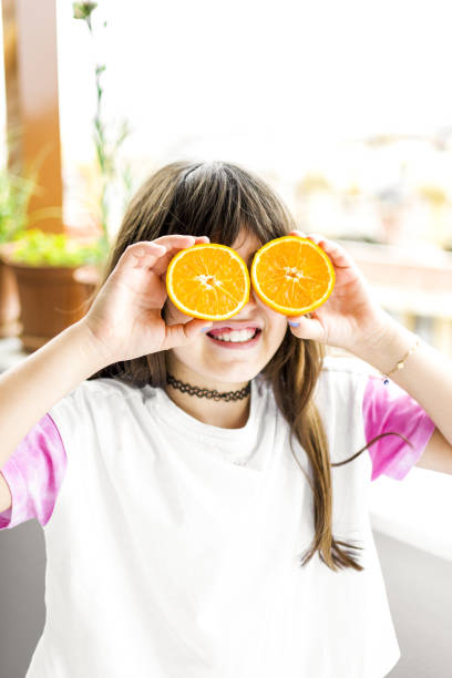 istock Beautiful girl posing with orange 1321123948