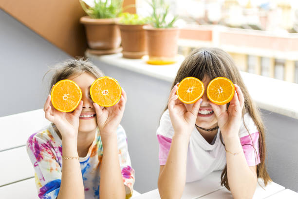 istock Beautiful girls posing with orange 1321124796