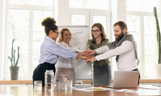 istock Young man and women, colleagues working together in modern office using devices and gadgets during negotiations 1321127529