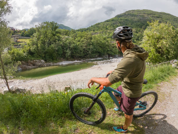 istock Man mountain biker rides along trail in Summer 1321129256