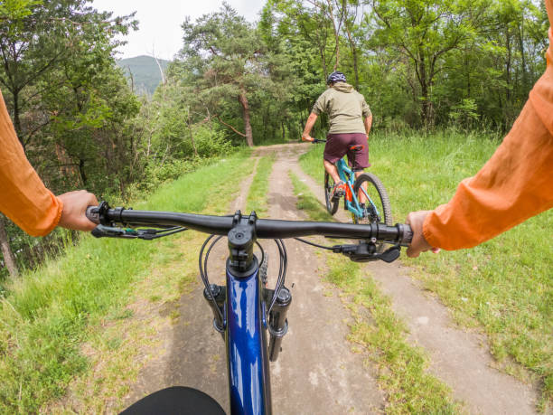 istock POV of mountain bikers on trail 1321129417