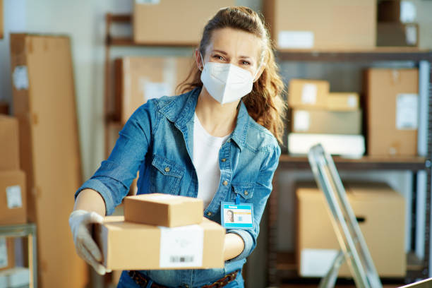istock modern female in jeans giving parcel in office 1321133002