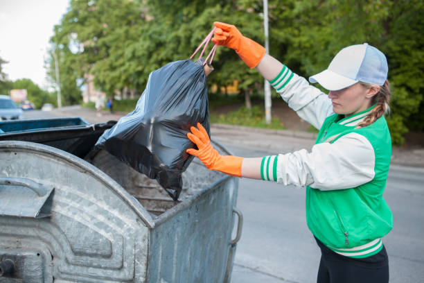 istock Volunteer picking trash in the forest 1321133792