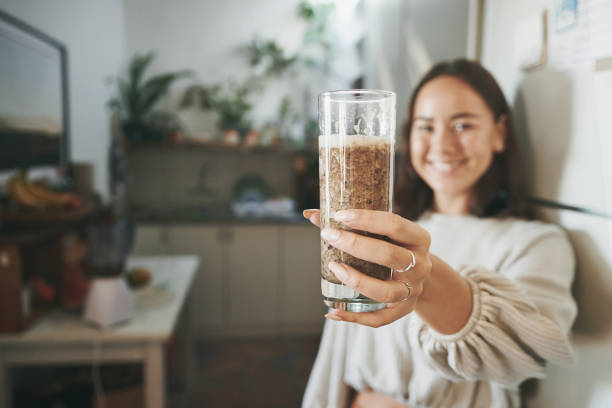 istock Shot of a young woman holding her smoothie before drinking it 1321135355