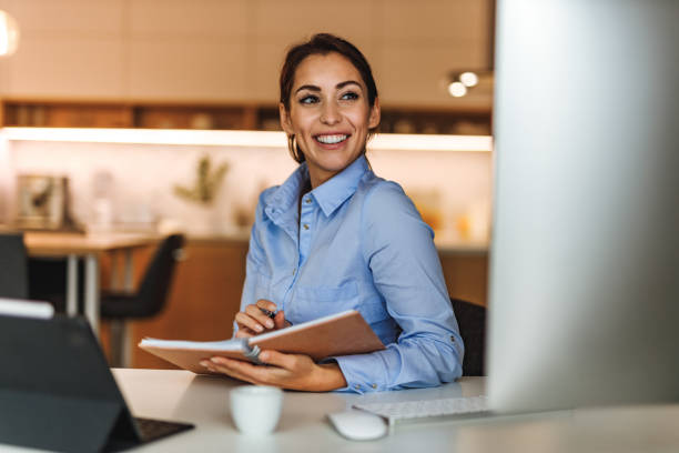 istock Smiling at monitor, looking happy. 1321135874