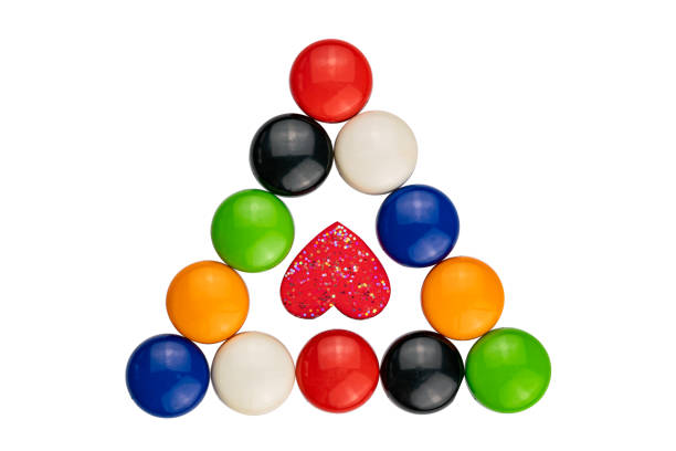 Multicolored magnets with red heart on white background with clipping path